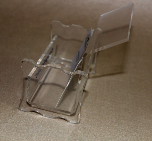 These clear plastic business card holders neatly display a single stack of  business cards. Holders measure 3-3/4"w by 2"h (back) by 1-1/4"d. Inside pocket.